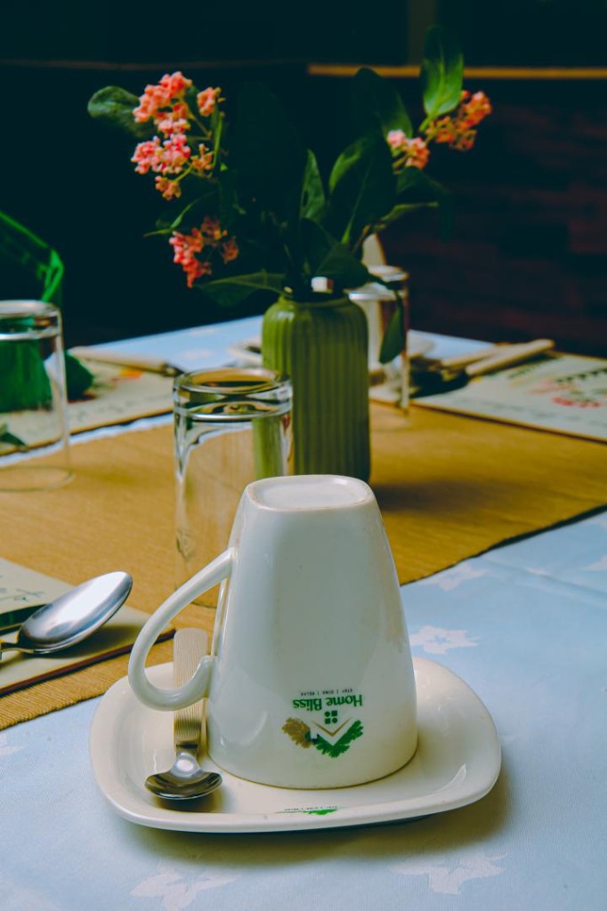 Home Bliss branded cup and saucer on a set dining table